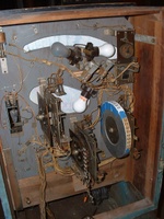 Image # 58737: Flying Saucers Inside Backbox 
(Blue tape on the replay wheel holds new and old numbered strips. The knocker can be seen in the upper left area.)
