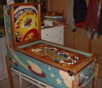 Image # 58736: Flying Saucers Cabinet - Full View 
(A coat of brown paint has been removed from the cabinet and rails, and from the playfield apron and trim. The white pop bumper cap printed with 'VENUS' is missing from the playfield.)