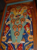 Image # 58733: Flying Saucers Playfield 
(The white pop bumper cap printed with 'VENUS' is missing in this picture. The words 'Tilt Reset' are inexplicably missing from the playfield directly below the red post between the flippers.)